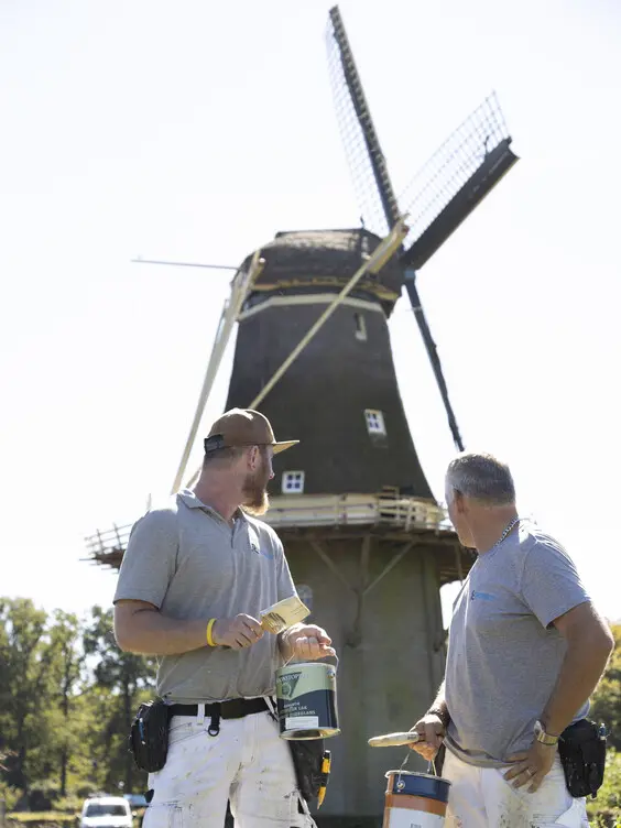 Windmill and two men in front of it